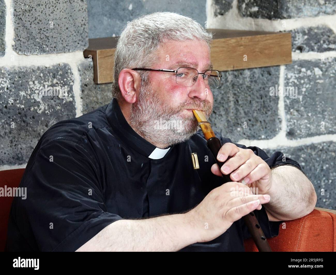 Senior Priest Abraham Firat plays a pipe during the ritual at Diyarbak?r Surp Hovsep Church. At the Surp Hovsep Armenian Catholic Church, which was heavily damaged in clashes between armed Kurdish PKK militants and Turkish security forces in the center of Diyarbakir in 2015 and repaired as a result of a 4-year restoration, the second ritual in the last 100 years after the first ritual in 2021. Very few Armenians who came from Istanbul and lived in Diyarbakir attended the ceremony. The ritual was led by Senior Priest Abraham Firat and Subordinate Deacon Jan Acemoglu, who were ordained from Ista Stock Photo