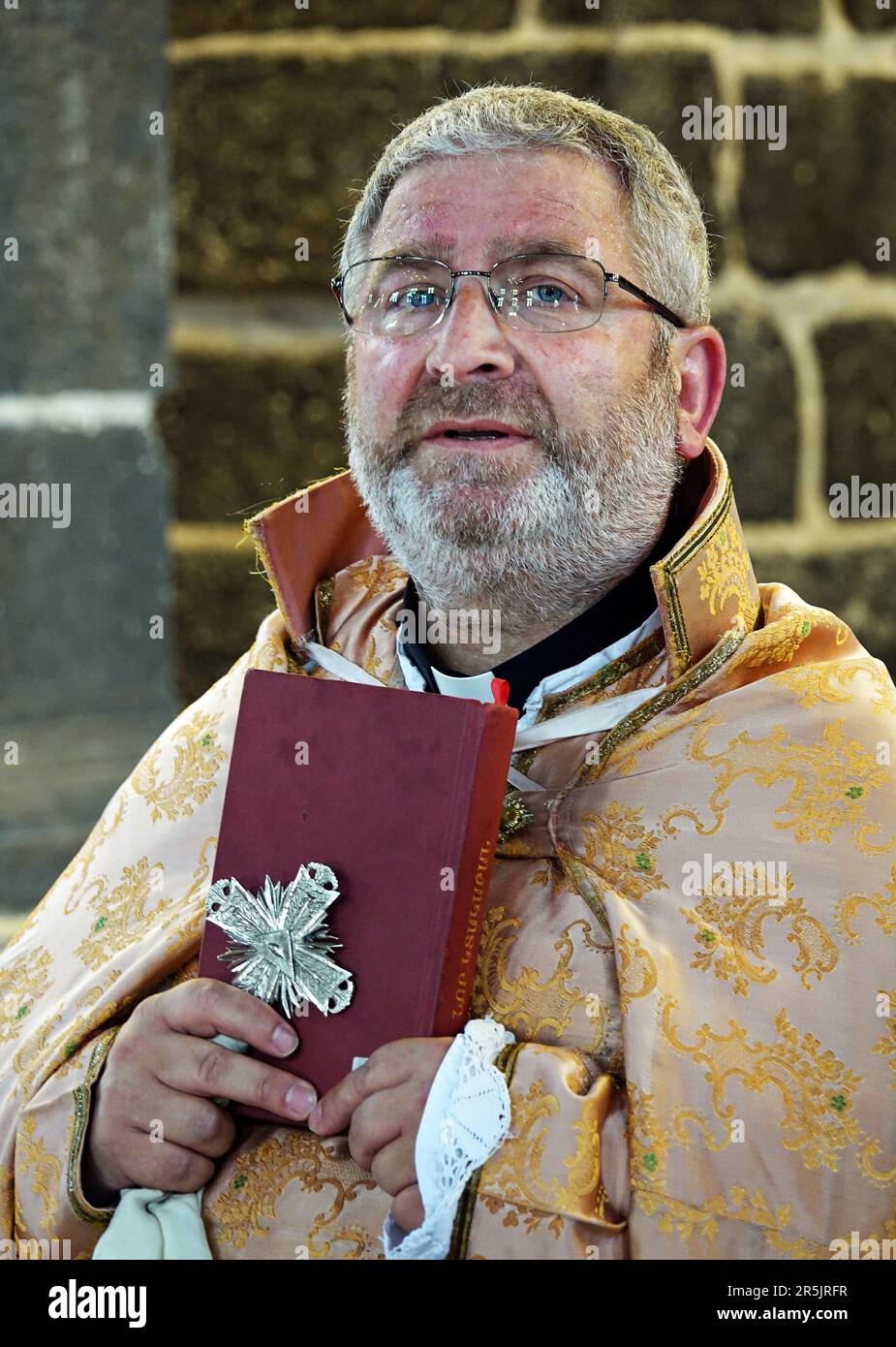 Senior Priest Abraham Firat seen preaching during the ritual at Diyarbak?r Surp Hovsep Church. At the Surp Hovsep Armenian Catholic Church, which was heavily damaged in clashes between armed Kurdish PKK militants and Turkish security forces in the center of Diyarbakir in 2015 and repaired as a result of a 4-year restoration, the second ritual in the last 100 years after the first ritual in 2021. Very few Armenians who came from Istanbul and lived in Diyarbakir attended the ceremony. The ritual was led by Senior Priest Abraham Firat and Subordinate Deacon Jan Acemoglu, who were ordained from Is Stock Photo