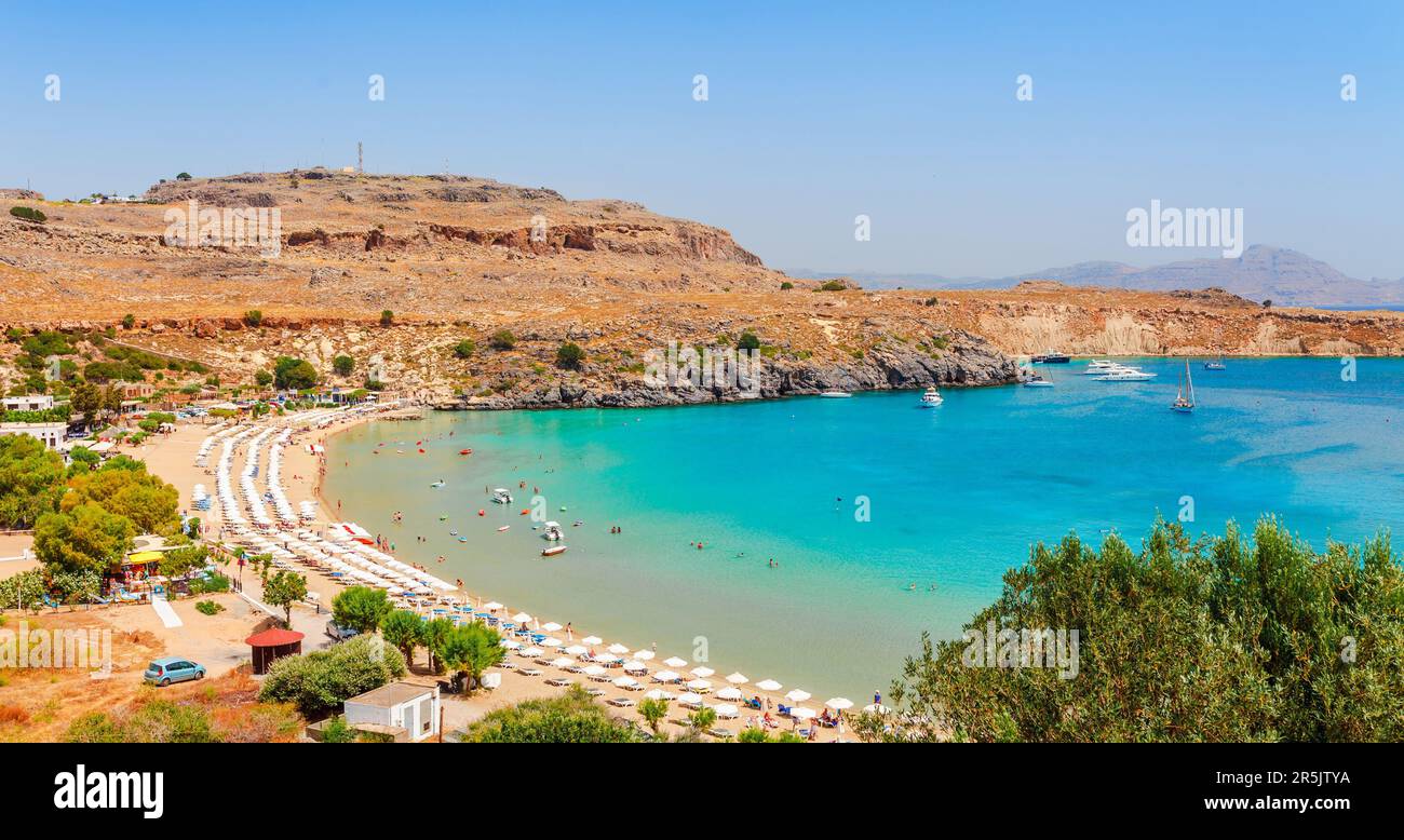 Sea skyview landscape photo Lindos bay and sea coast on Rhodes island, Dodecanese, Greece. Panorama with nice sand beach and clear blue water. Famous Stock Photo