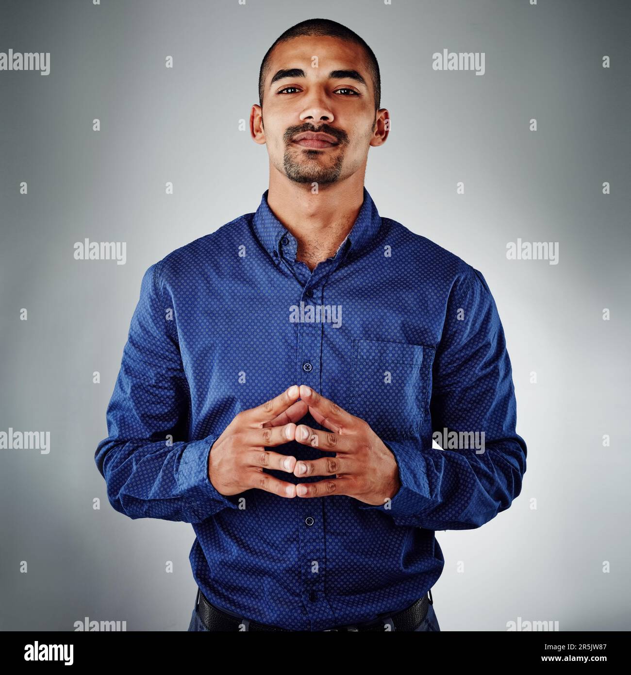 Being smart is more than having a high IQ...a young businessman posing against a grey background. Stock Photo