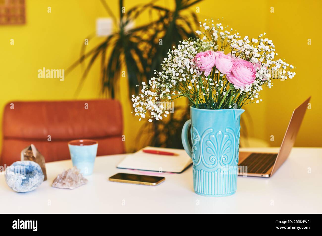 Colorful workplace with portable laptop computer, mineral crystals and ...