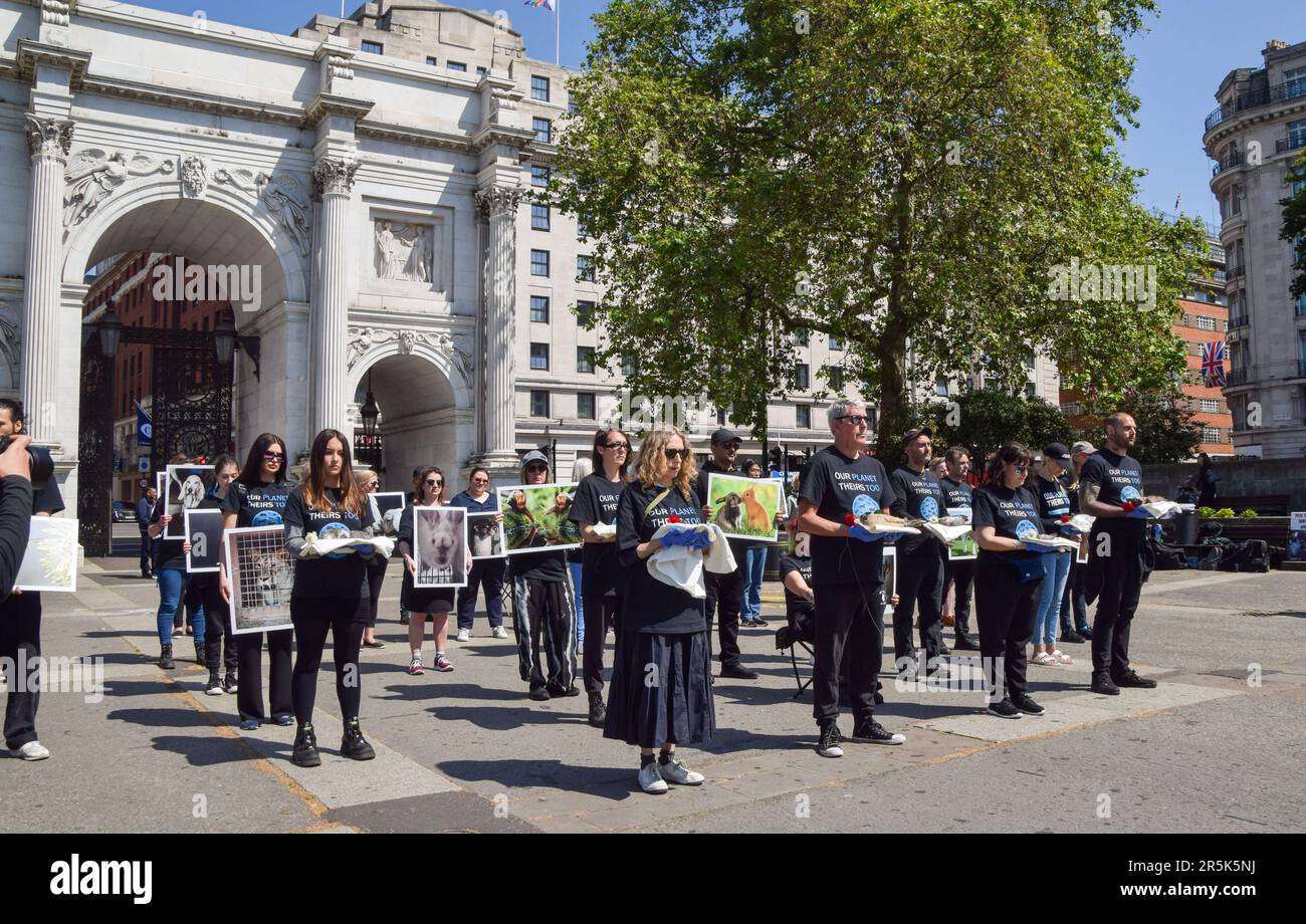 London, UK. 4th June 2023. Activists holding pictures of animals and