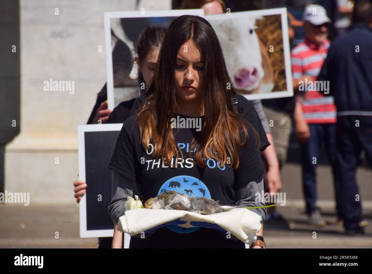 London, UK. 4th June 2023. Activists holding pictures of animals and