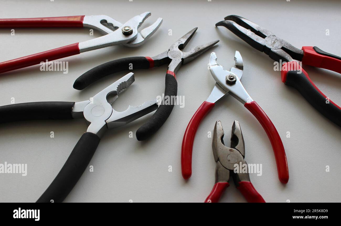 Set Of Different Types Of Mechanics Pliers On White Surface Detailed Stock Photo Stock Photo