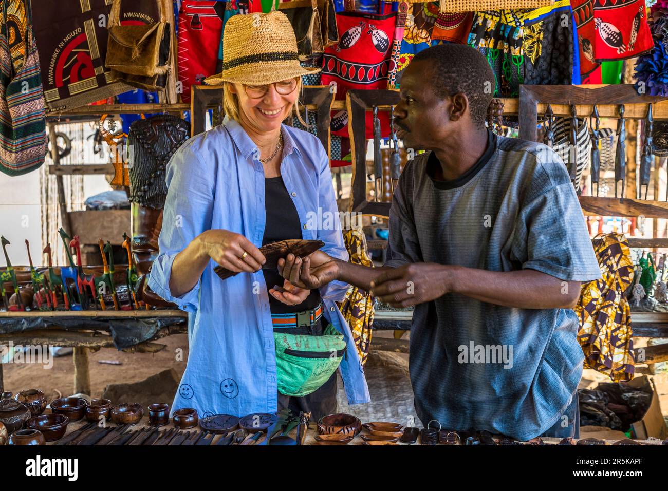 Printed textiles and wood carvings are popular souvenirs from Malawi. Curio Market in Lilongwe Stock Photo