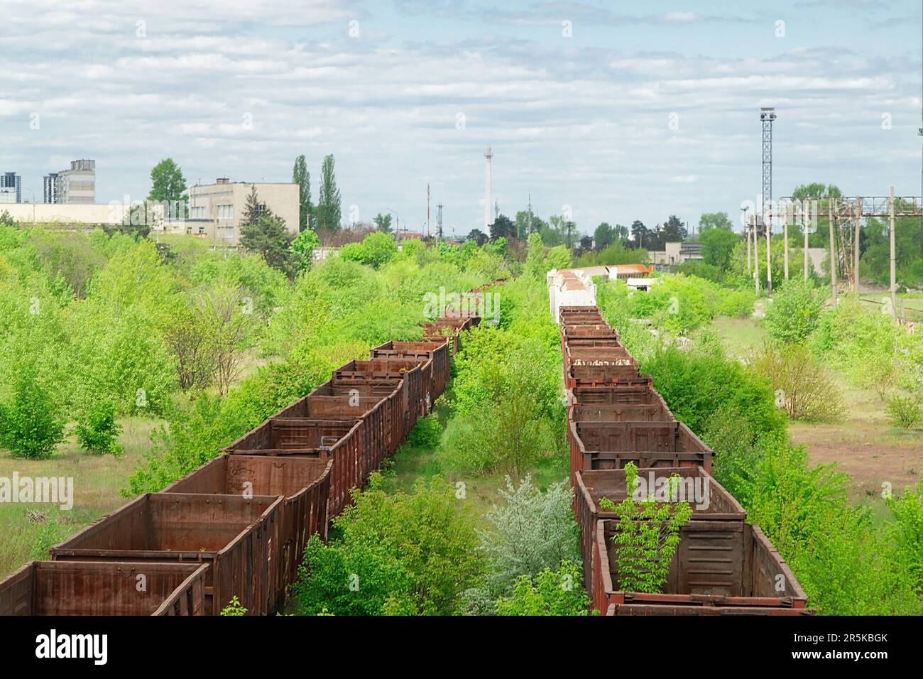 Abandoned rusty railway carriage at old lifeless railway Stock Photo