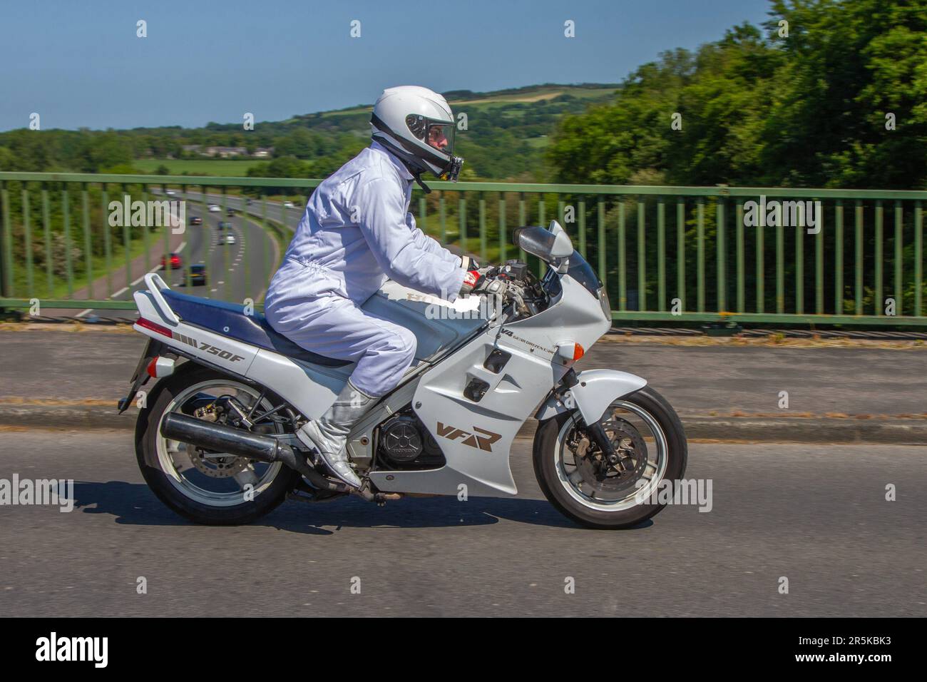1986 80s eighties White Honda VFR 750 F G V4 Gear driven Cams Vfr 750 F G V Four White Motorcycle Sports Petrol 748 cc Motorbike rider wearing White Motorcycle Riding Suit two wheeled