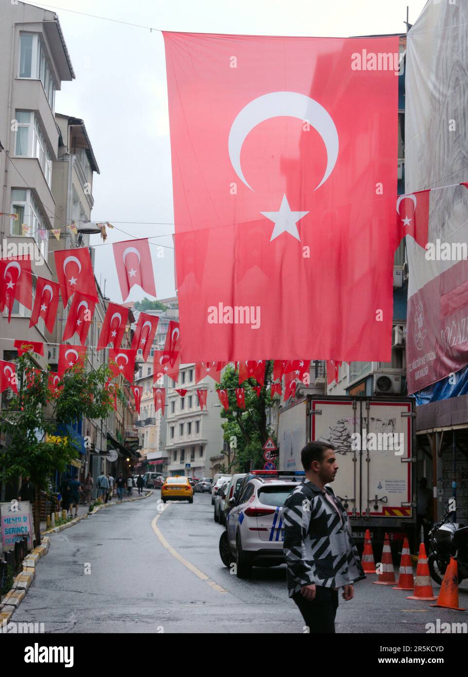 Man walks under large flag of Turkey in Istanbul, Turkey or in the Republic of Türkiye. Stock Photo