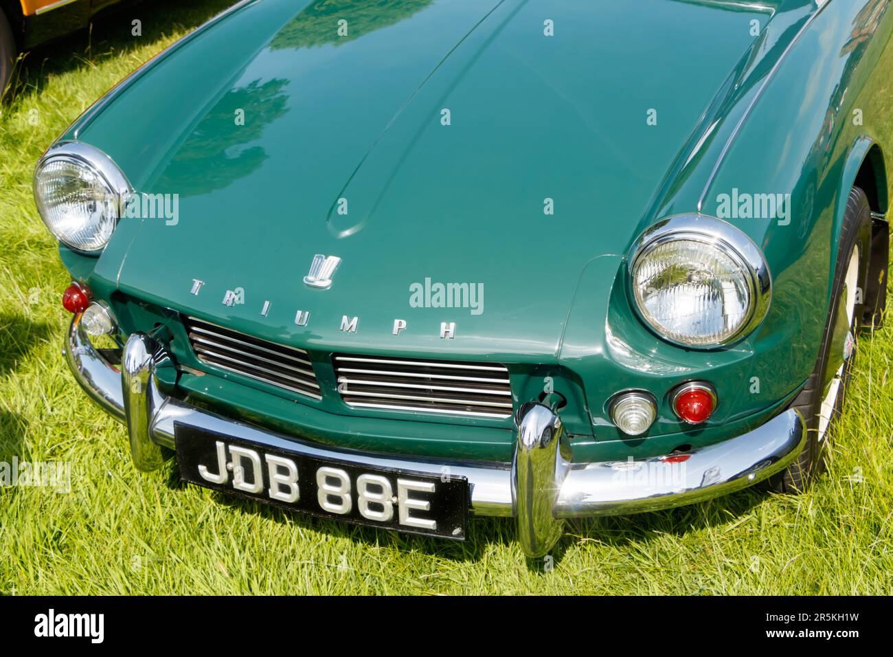 front view bonnet of green classic 1960s triumph 1967 60s  Spitfire Mk2 British sports car convertible at vintage classic car show Capesthorne Hall Ch Stock Photo