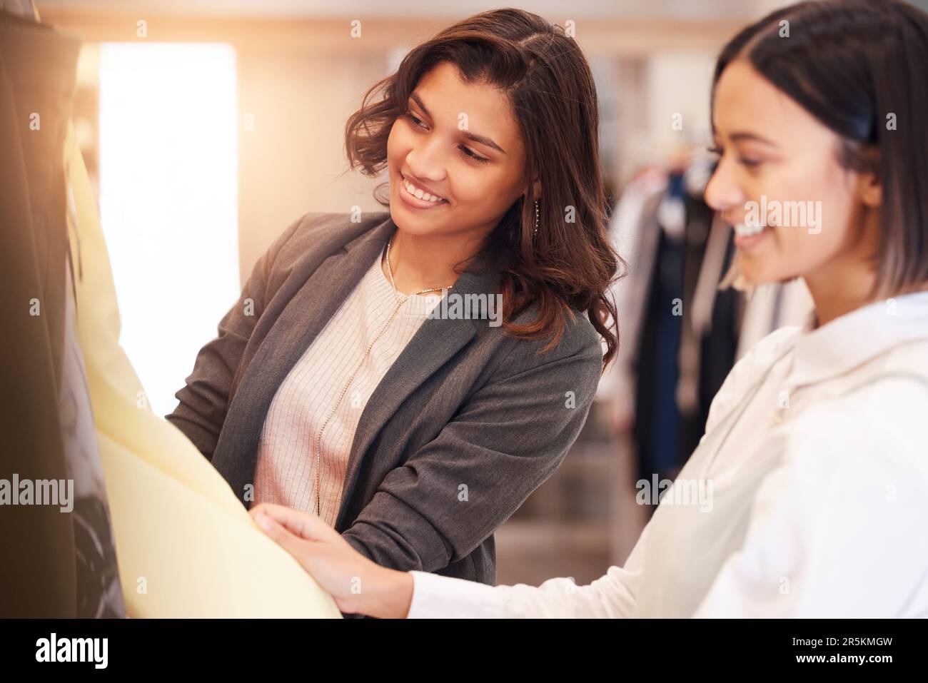 Fashion, retail and customer friends shopping in a mall together while searching for sales in a clothing store. Consumerism, smile, or happy with a Stock Photo