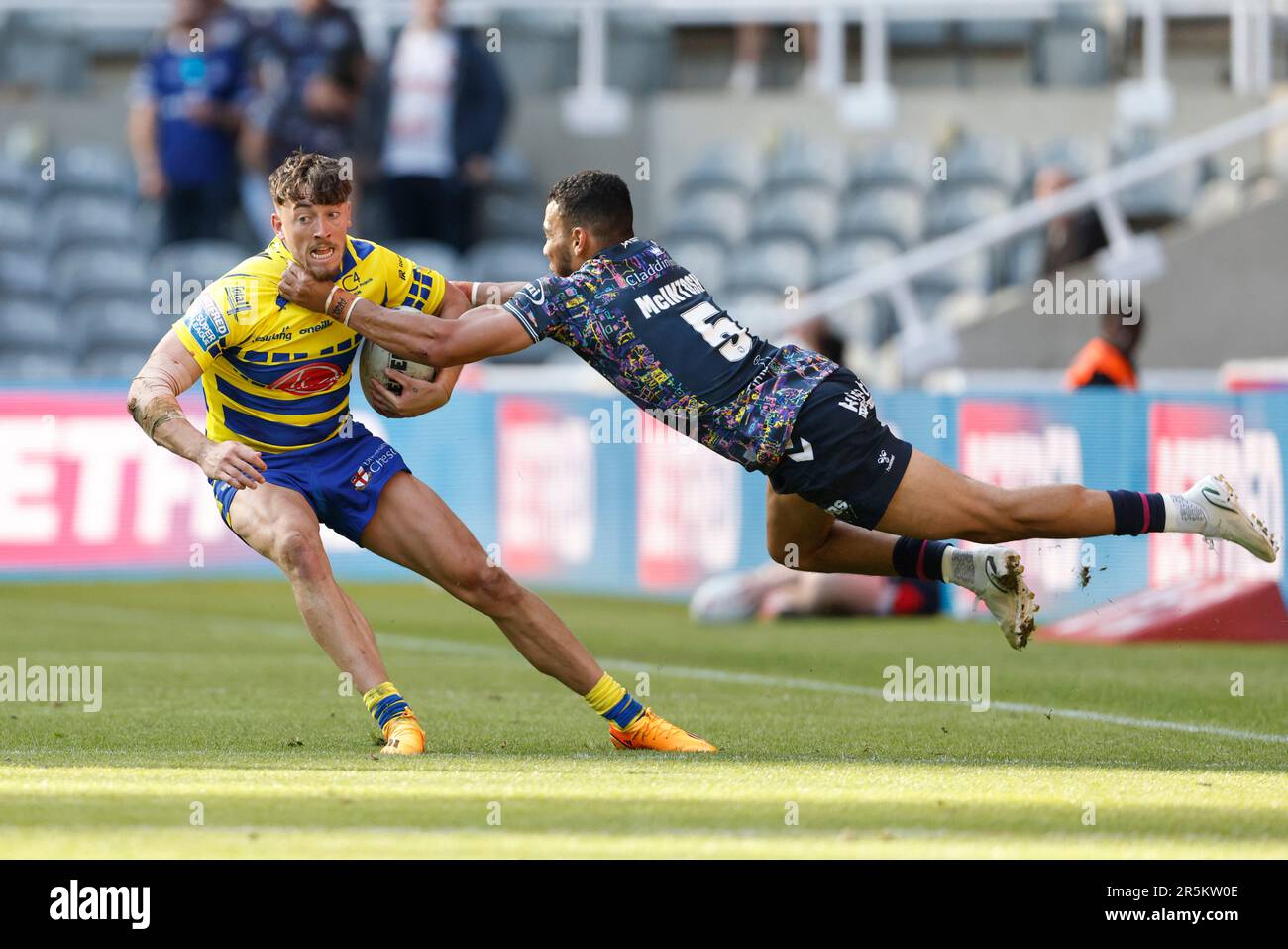 Warrington Wolves’ Matty Ashton is tackled by Hull FC’s Darnell McIntosh during the Betfred Super League match at St. James' Park, Newcastle upon Tyne. Picture date: Sunday June 4, 2023. Stock Photo