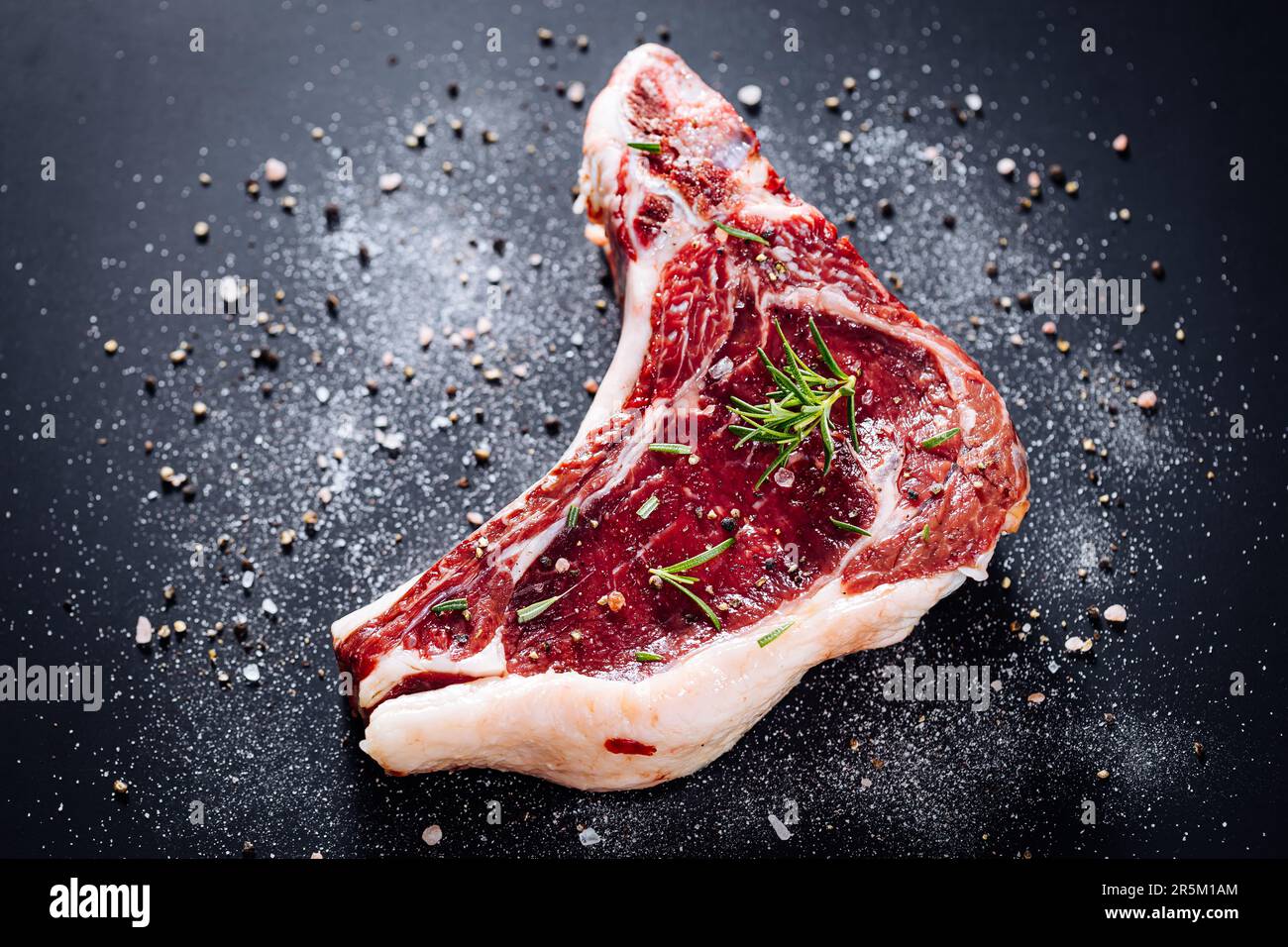 Raw cut of premium steak with bone. Rump steak with marble, dry aged