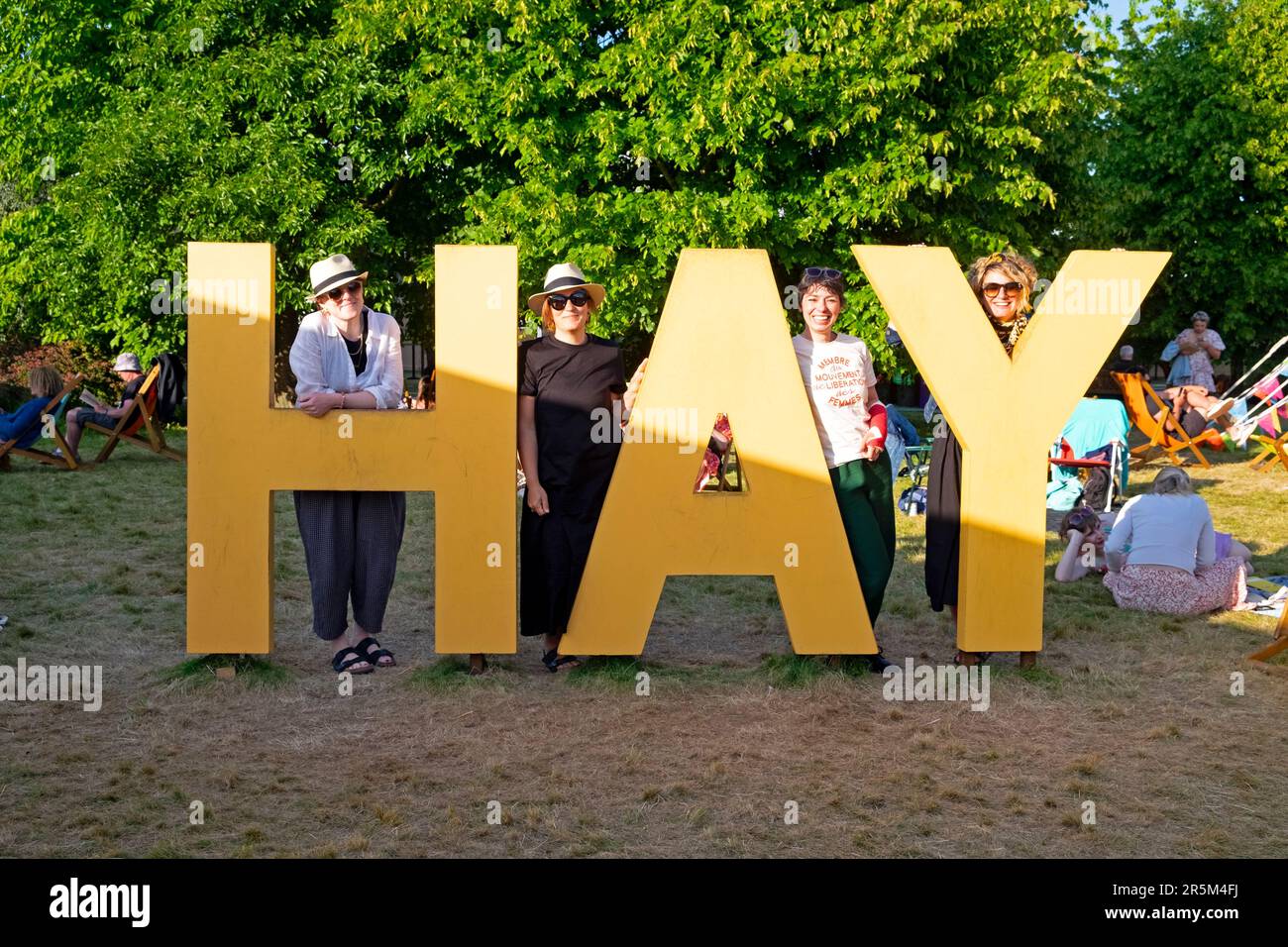 Members of the Cardiff Womens Feminist Book Club standing by the huge Hay sign at the Hay Festival 2023 in Hay-on-Wye Wales UK  KATHY DEWITT Stock Photo