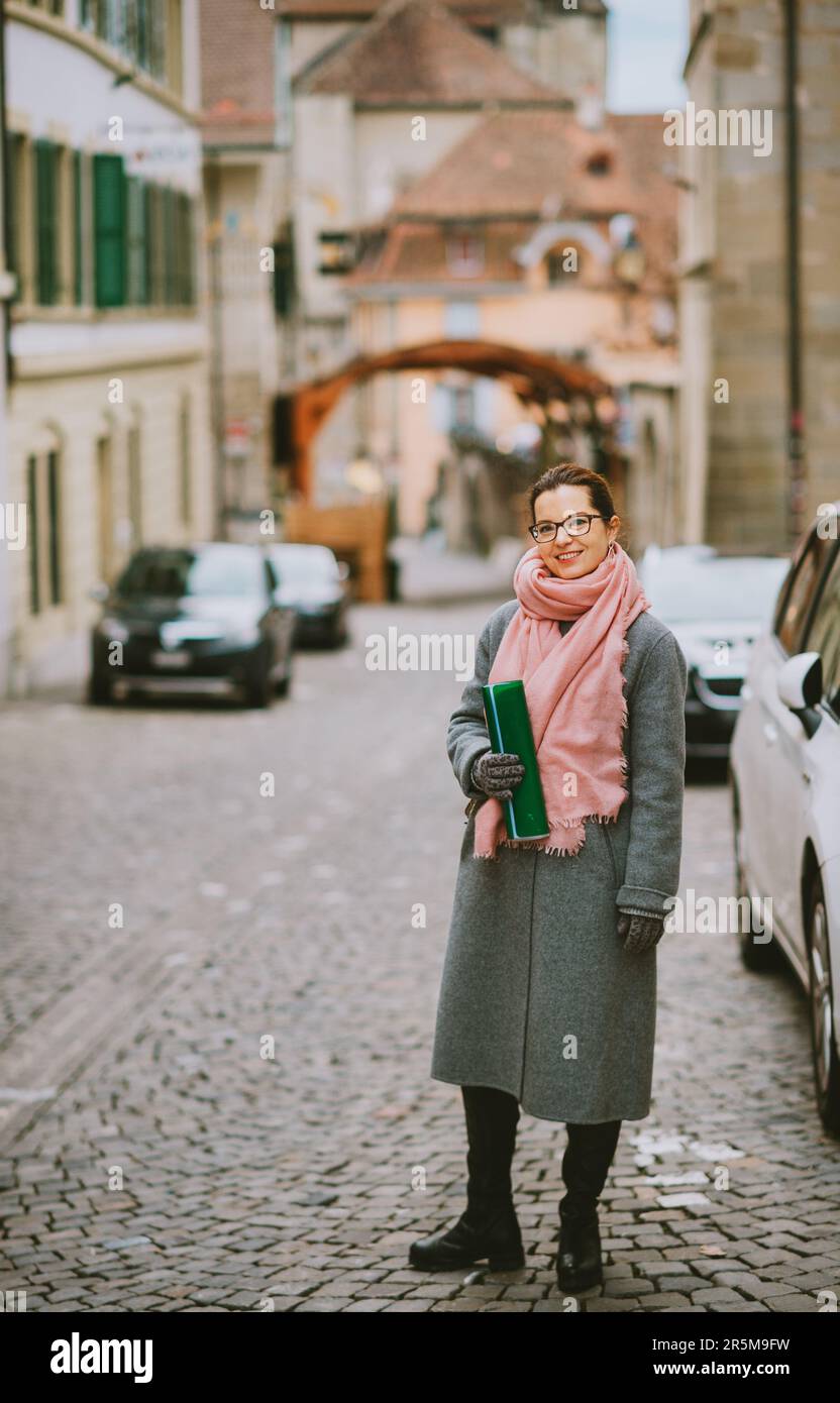 Outdoor portrait of beautiful woman wearing grey coat Stock Photo