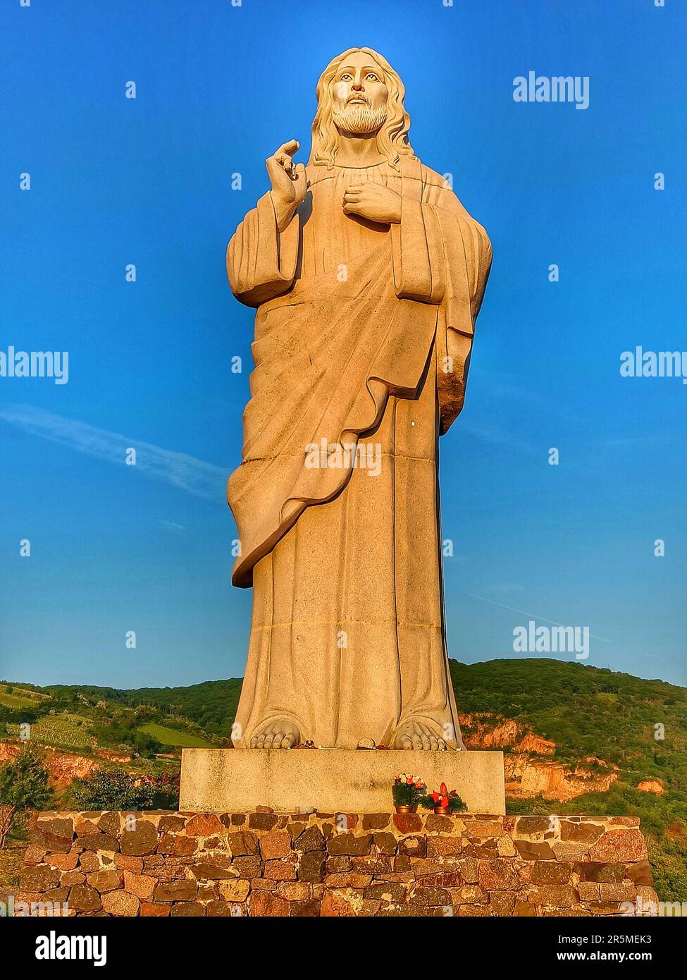 Blessing Jesus Christ monument (Áldó Krisztus) in Tarcal, Tokaj region, Hungary. Giant religious statue during sunset. Stock Photo