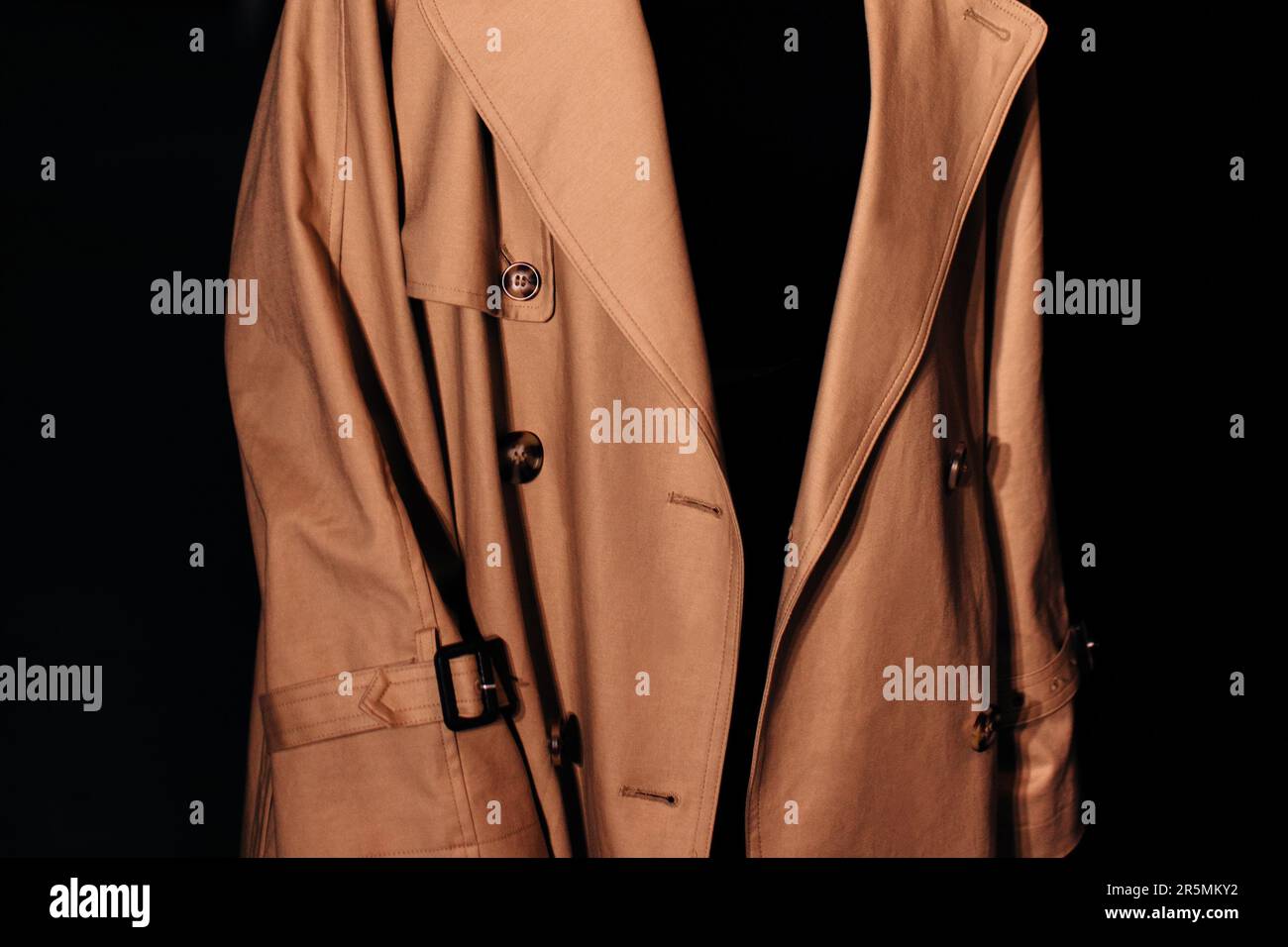 Details of autumn brown classy coat. Unisex street style fashion cloth concept. Black background Stock Photo