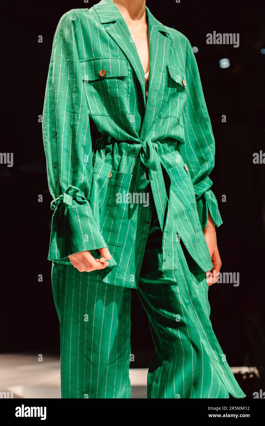 Fashion details of stylish green outfit. Classy jacket, cotton pants. Fancy cloth concept Stock Photo