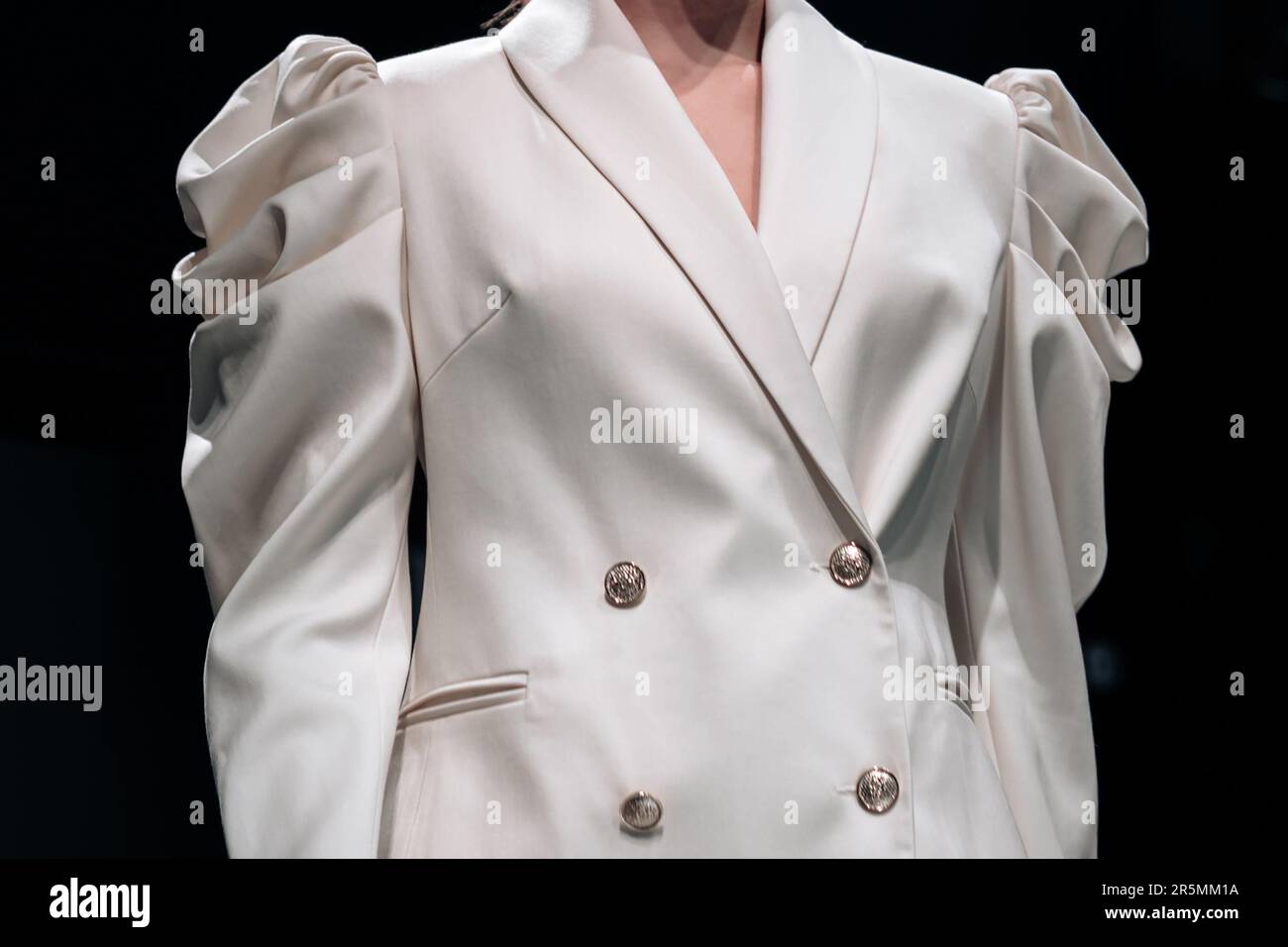 Classy white jacket with buttons on female body. Fashion fancy details. Style, design of women's clothing and accessories. Stock Photo