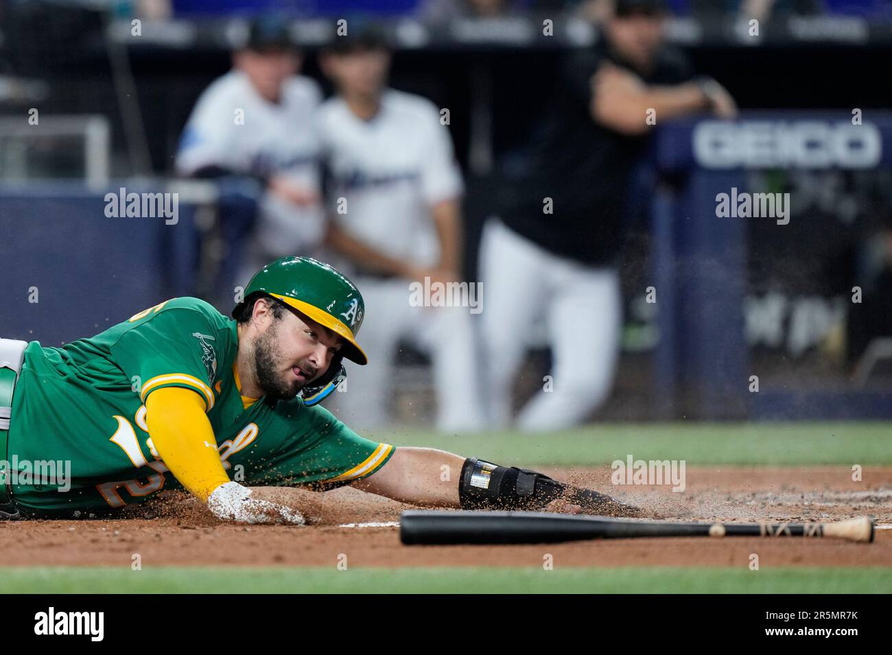 Oakland Athletics' Shea Langeliers slides into home plate to score on a  single by Esteury Ruiz during the third inning of a baseball game against  the Miami Marlins, Sunday, June 4, 2023