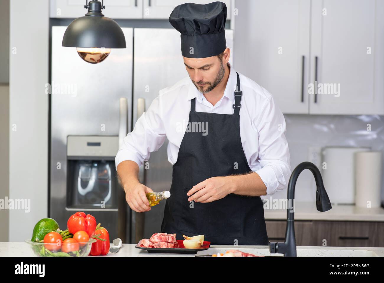 Premium Photo  Chef mature man cook wear apron in kitchen handsome man  preparing food in kitchen guy cooking a tasty meal man on kitchen with meat  and vegetables portrait of casual
