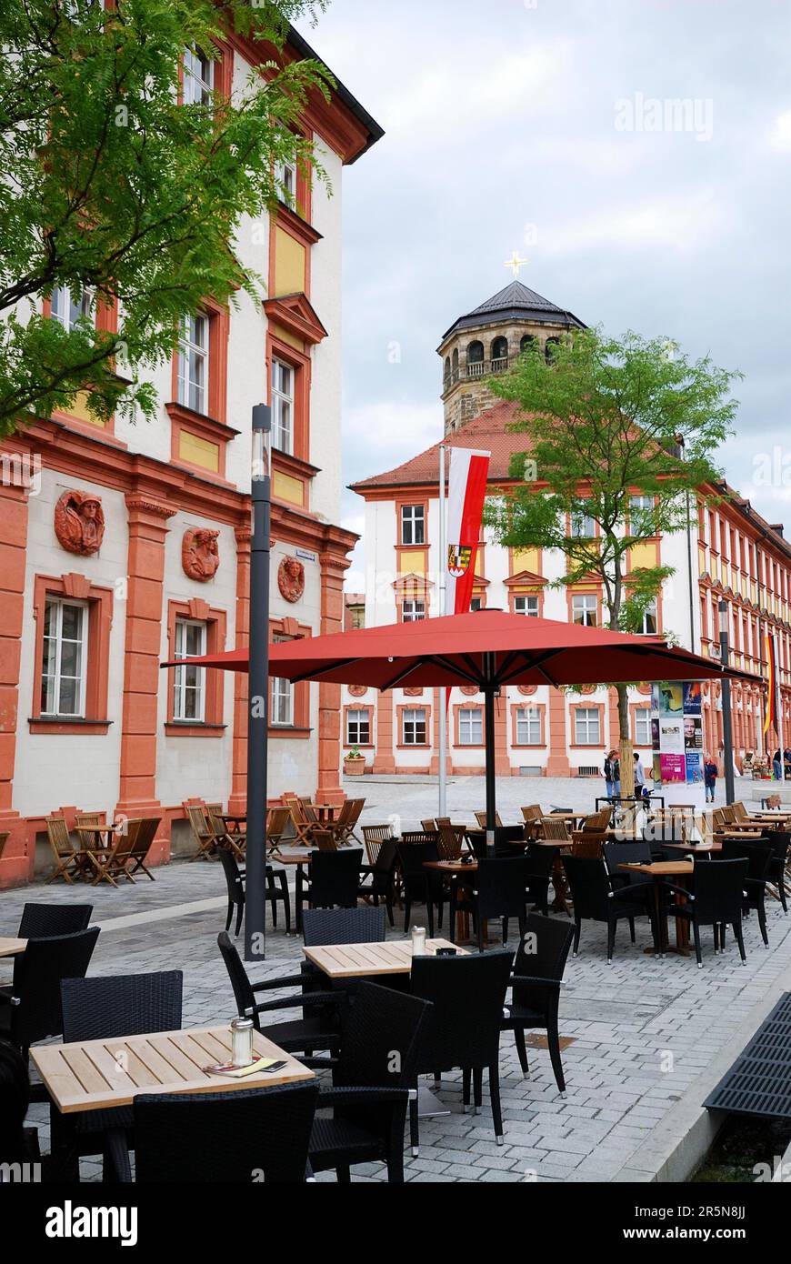 BAYREUTH, GERMANY, JUNE 25: Street cafe in the Maximilian street of Bayreuth on June 25, 2011. View towards the tower of the old castle (Altes Stock Photo