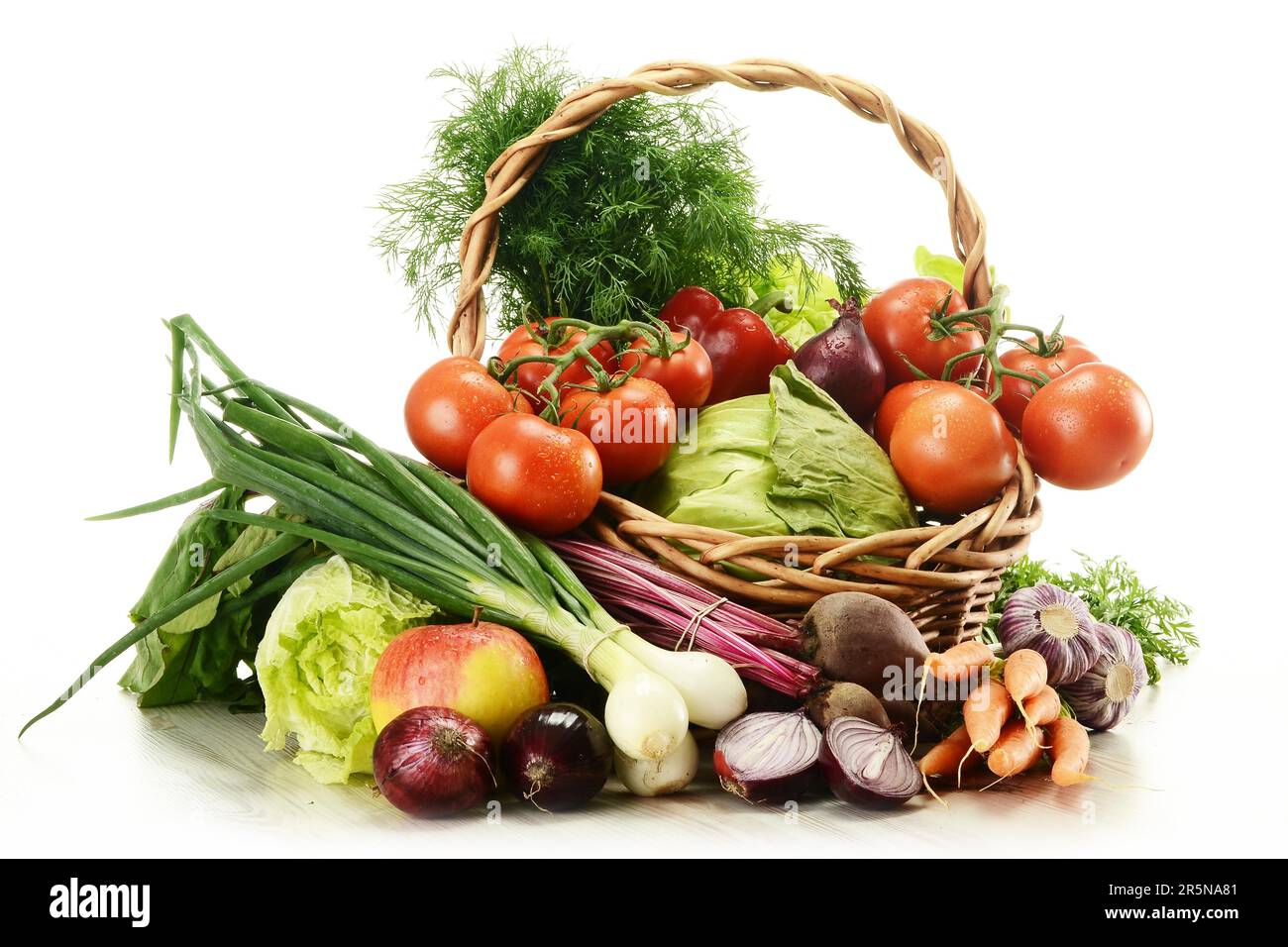 Composition with raw vegetables and wicker basket isolated on white Stock Photo