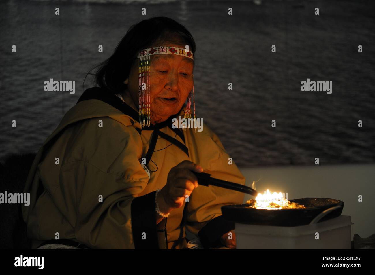 Inuit shaman burns oil at ceremony, Pond Inlet settlement, Baffin Island, Nunavut, Canada, incantation, shaman, Inuit, Eskimo, shaman, Baffin Island Stock Photo