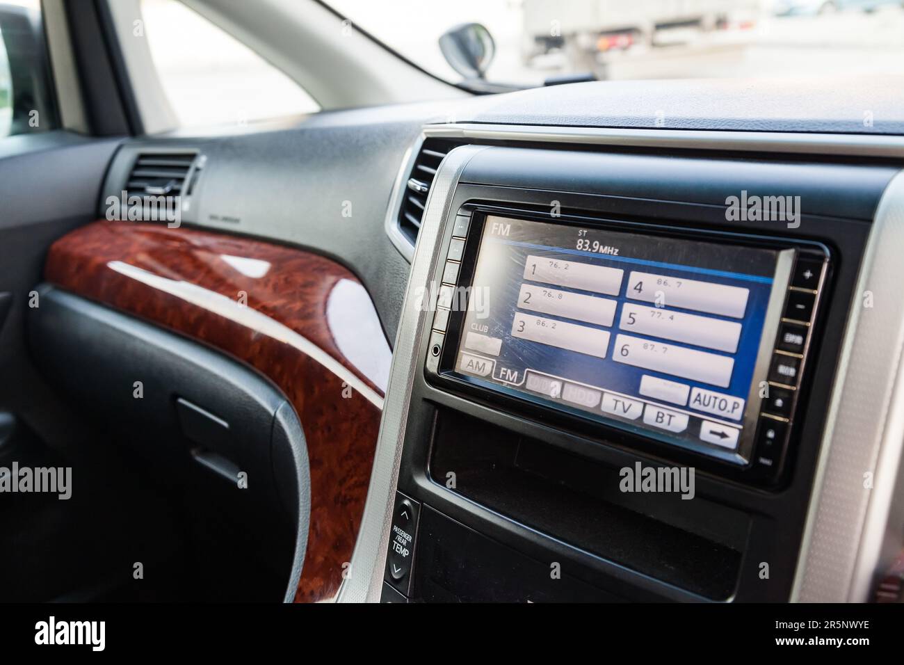 The central control console on the panel inside the car close-up with a  computer display, an audio system and a radio in gray and black plastic.  On-bo Stock Photo - Alamy