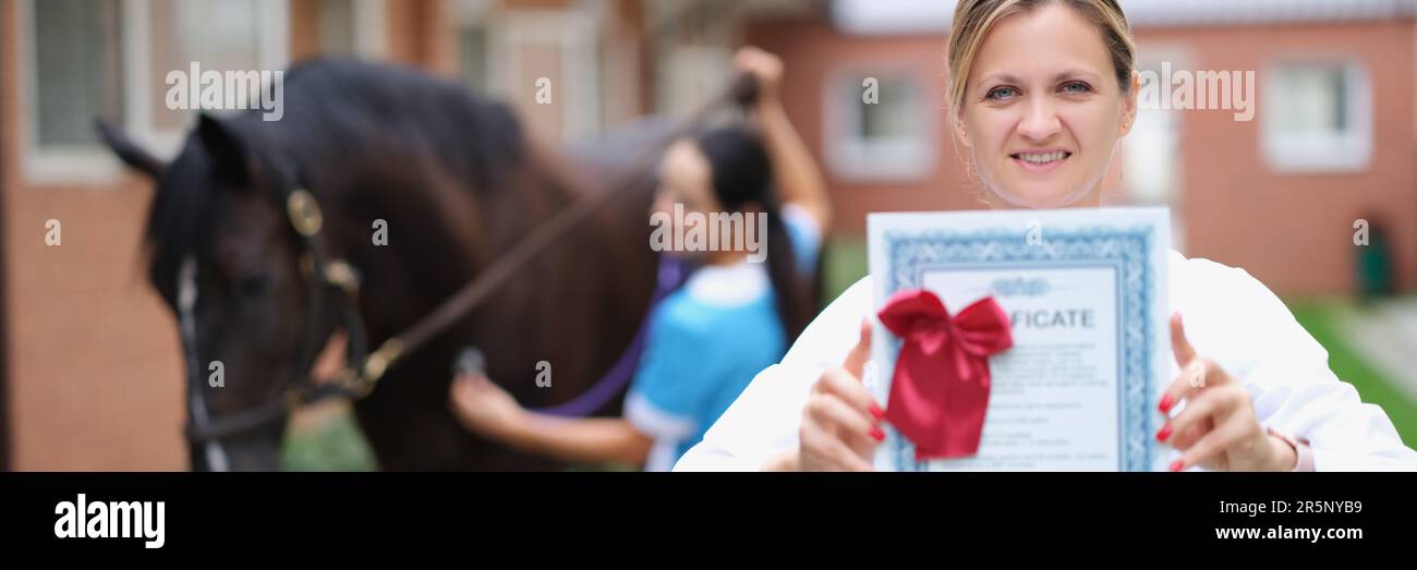 Woman veterinarian holds medical certificate for horse. Medical