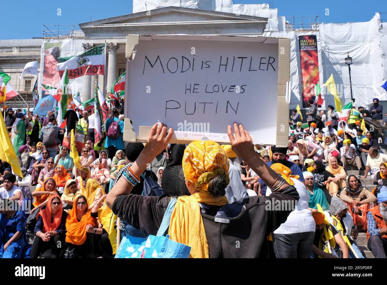 London, UK. A Sikh woman holds up a placard 'Modi is Hitler. He loves Putin', during the event to commemorate the Golden Temple massacre. Stock Photo
