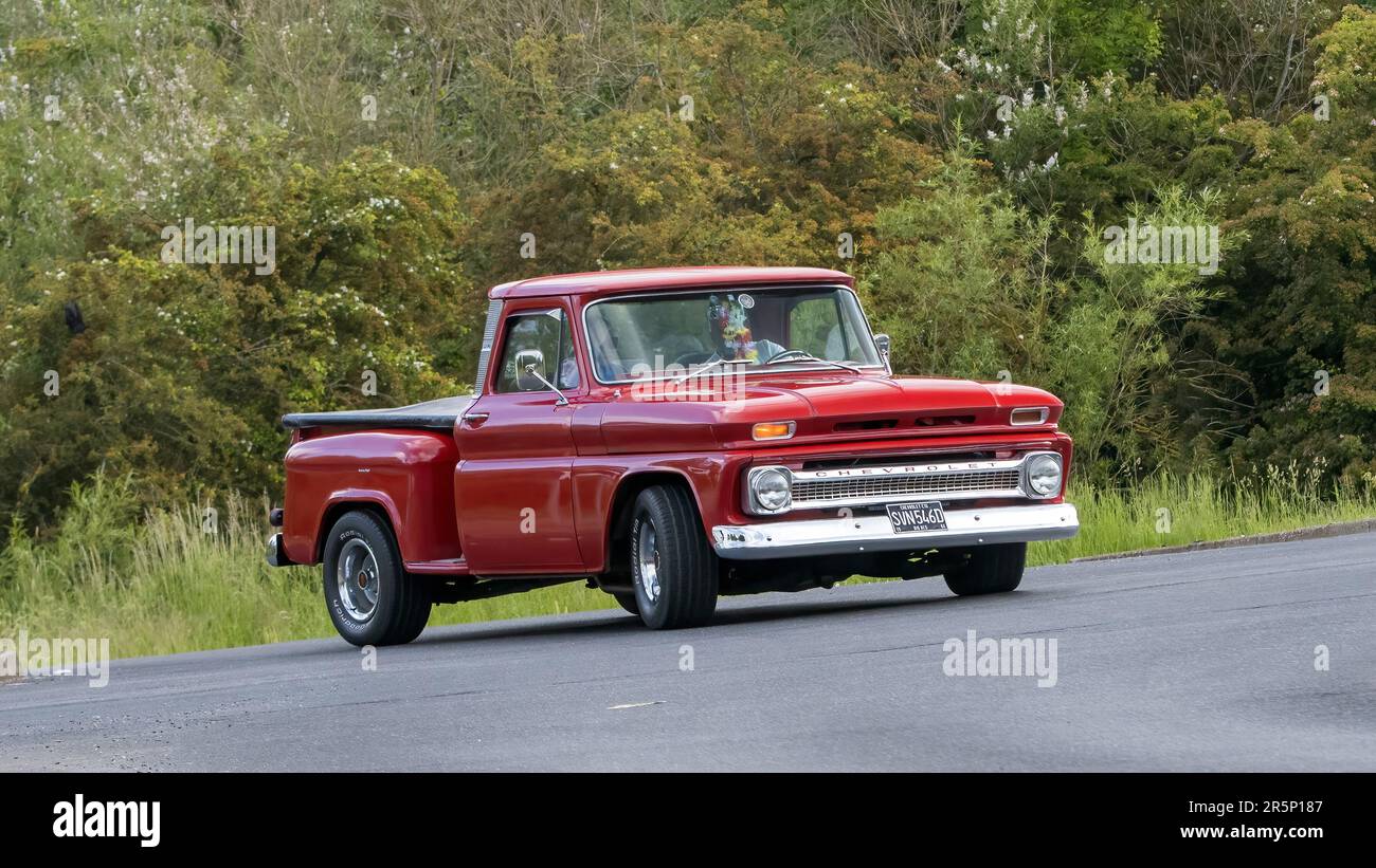 Stony Stratford,UK - June 4th 2023: 1966 red CHEVROLET C10 PICKUP classic car travelling on an English country road. Stock Photo