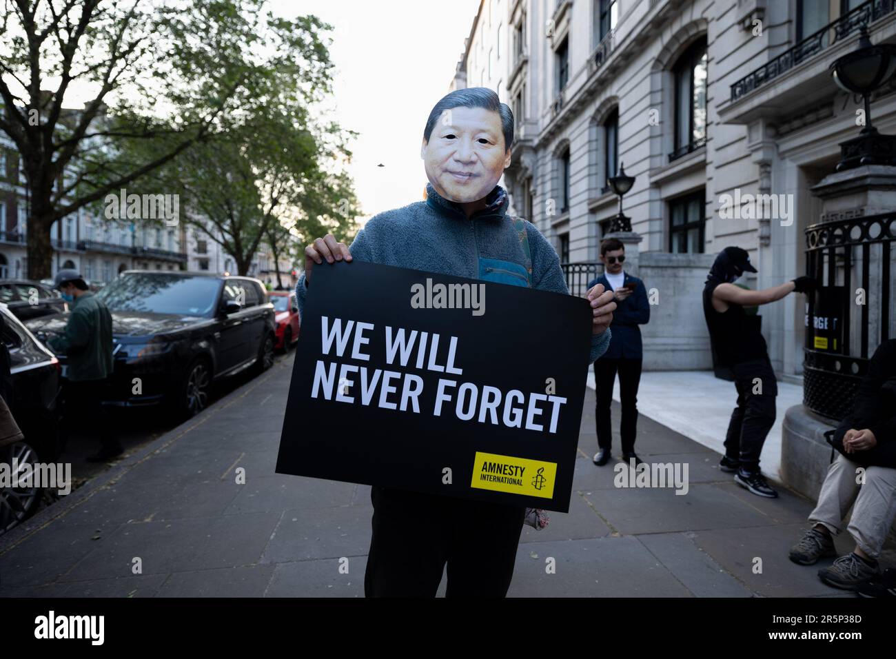 London, UK. 04th June, 2023. A participant wearing a mask to disguise as Xi Jinping is seen holding a poster during the vigil. A candle-lit vigil organised by the Amnesty International took place outside the Chinese Embassy in London as a tradition in memorial of the people who died in the 1989 Tiananmen Massacre. (Photo by Hesther Ng/SOPA Images/Sipa USA) Credit: Sipa USA/Alamy Live News Stock Photo