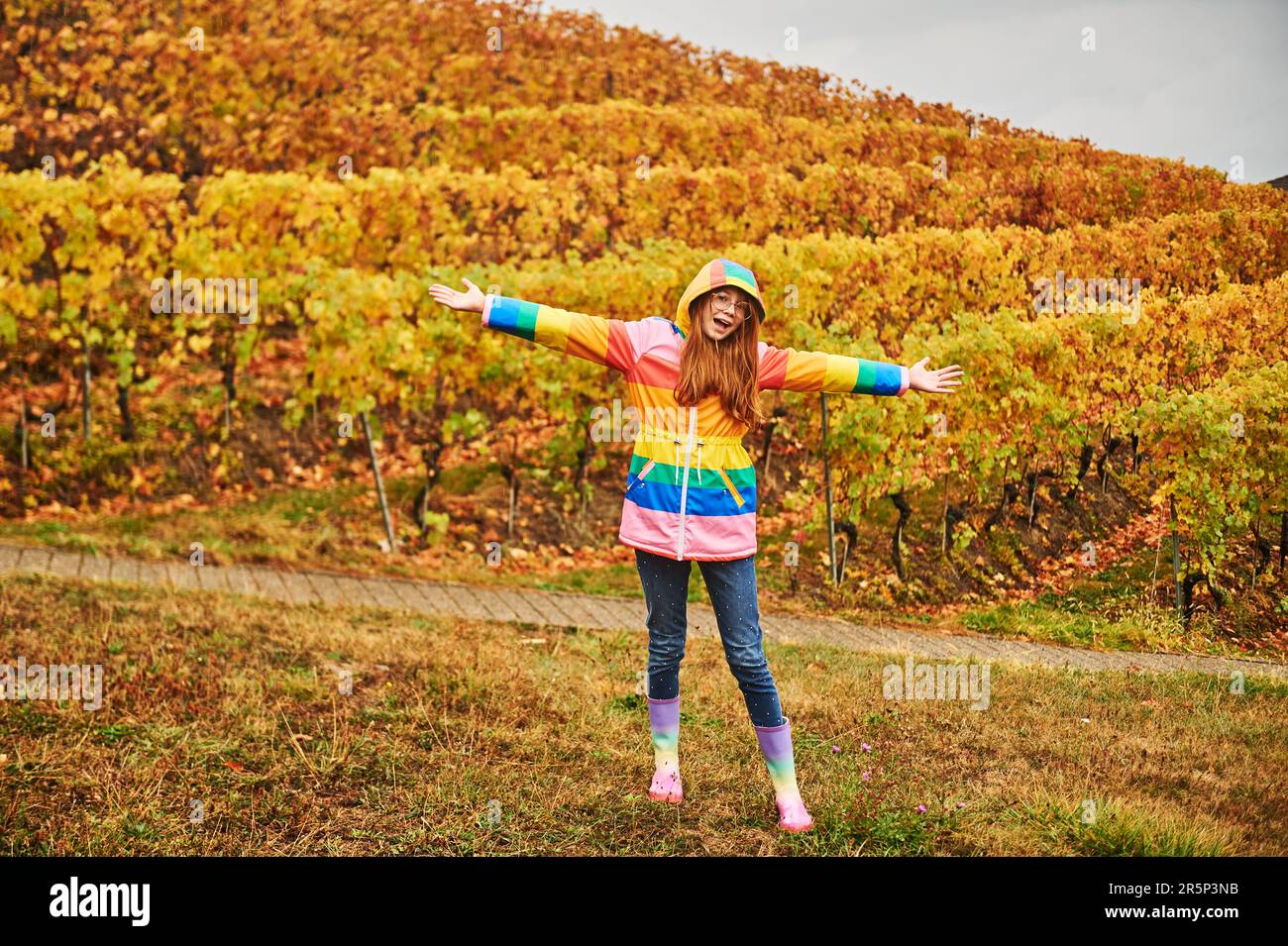 Outdoor portrait of pretty young girl wearing colorful rain coat Stock Photo Alamy