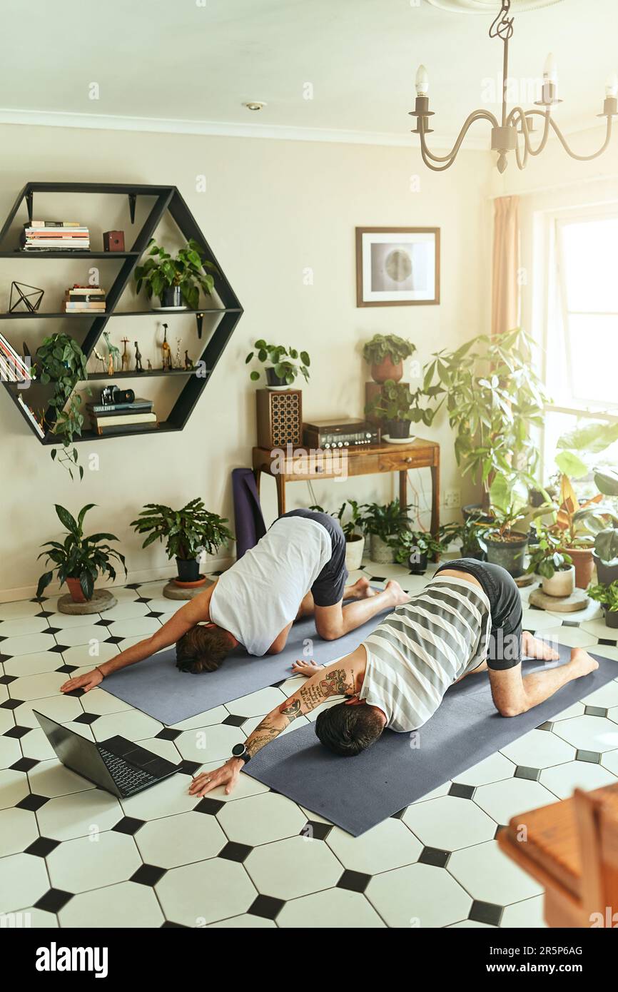 All hail the yoga instructor. two men using a laptop while going ...