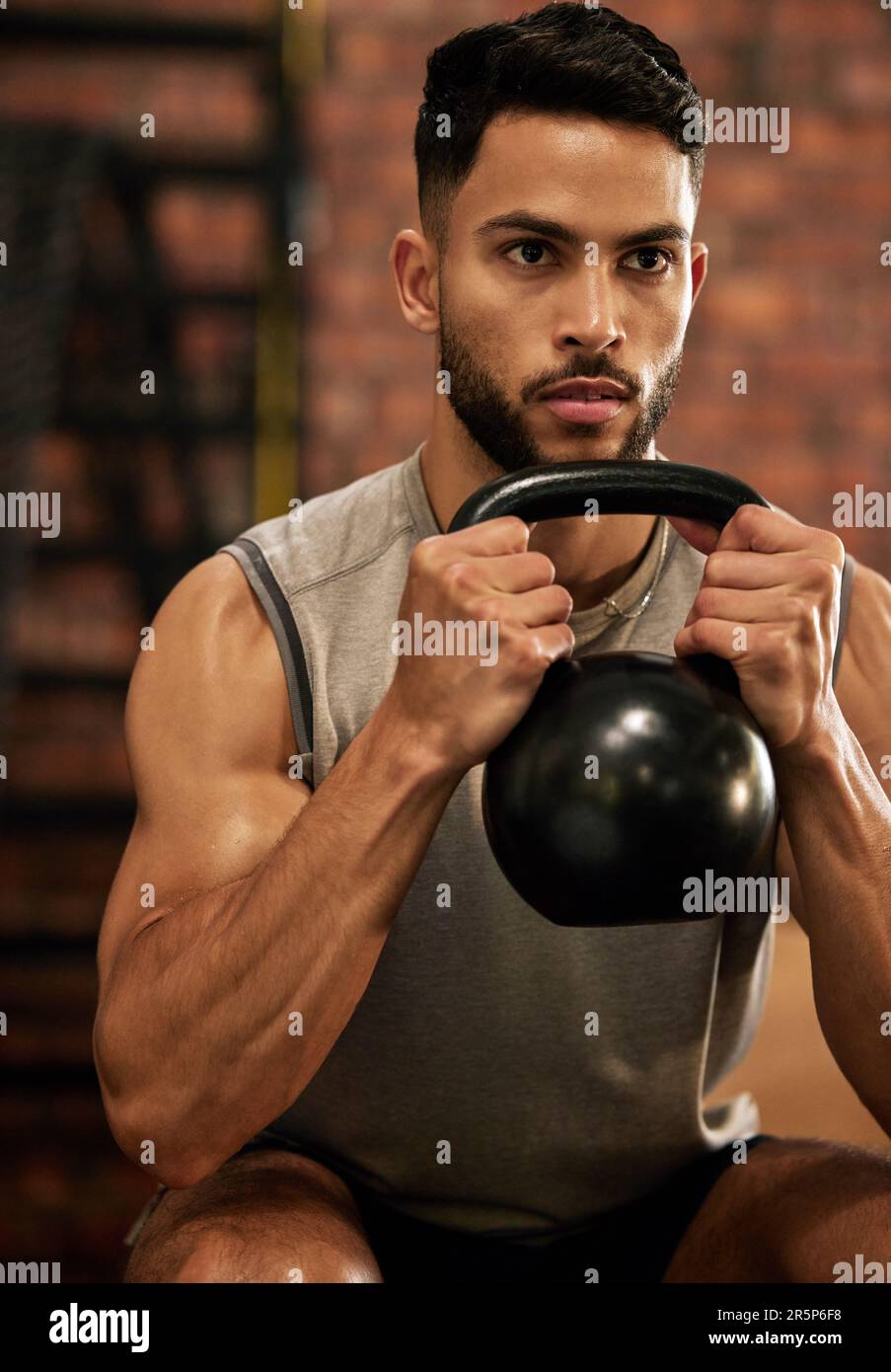 Weightlifting training and man with kettle bell in gym for