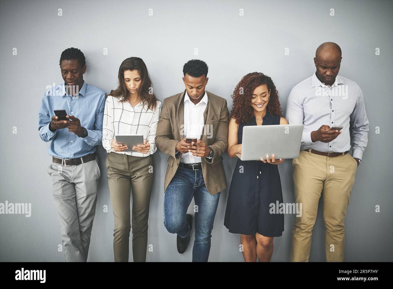 Millenial Using Technology What are millennials without technology. Studio shot of a group of ...