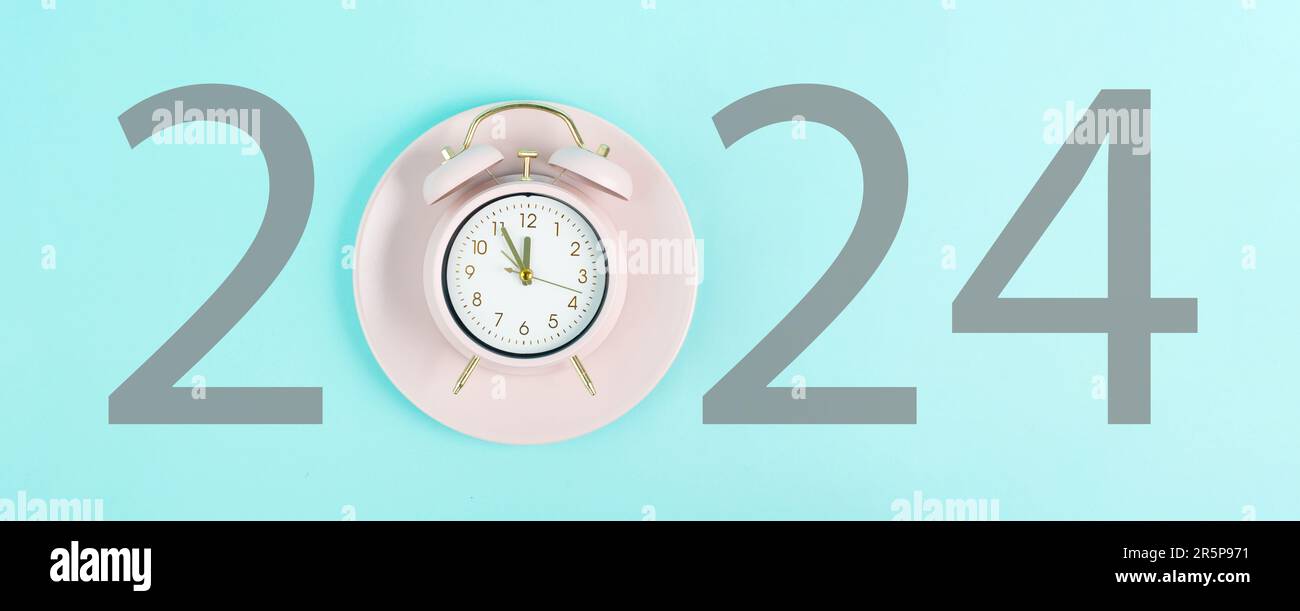 New year 2024 is loading, calendar date on an alarm clock, end of the