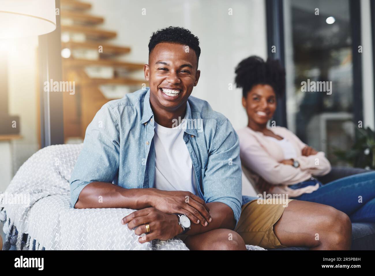 Loving young caucasian couple sitting together at home spending