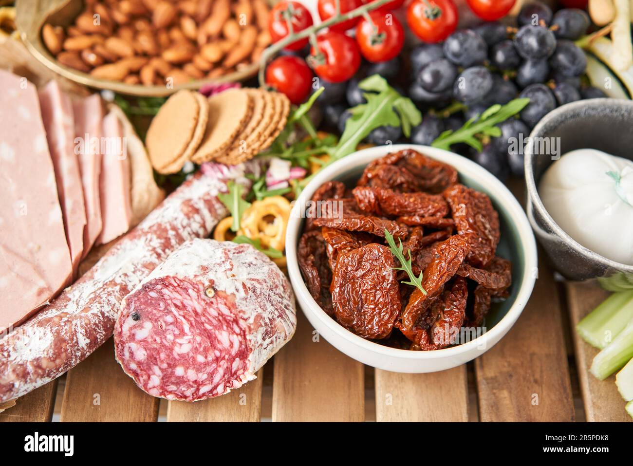 Salami sausage close-up. Table full of mediterranean appetizers, tapas ...