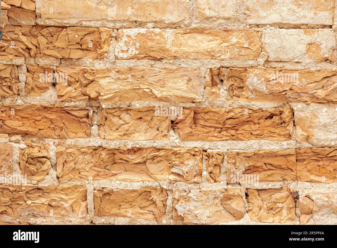 Background from an old brick wall with bricks crumbling from age Stock Photo
