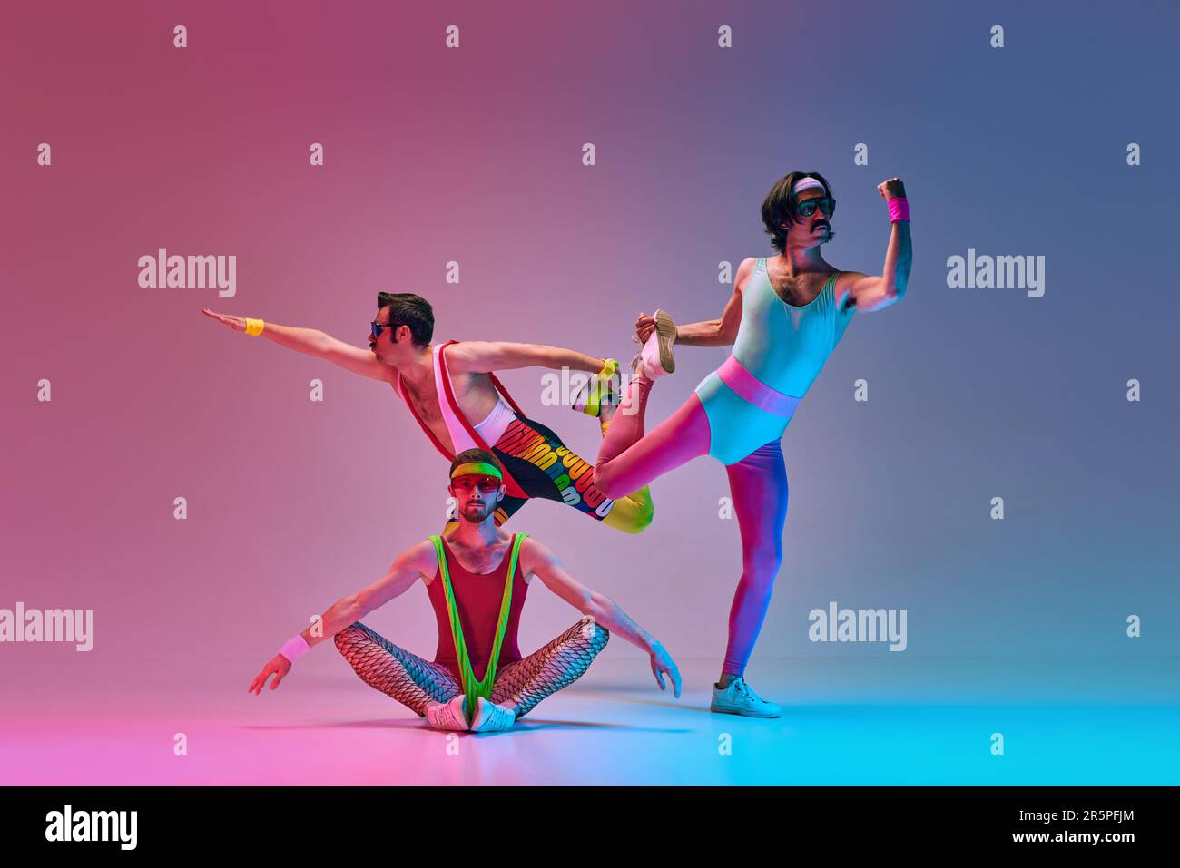 Flexible, stylish men in vintage sportswear training, stretching against  gradient blue pink studio background in neon light Stock Photo - Alamy
