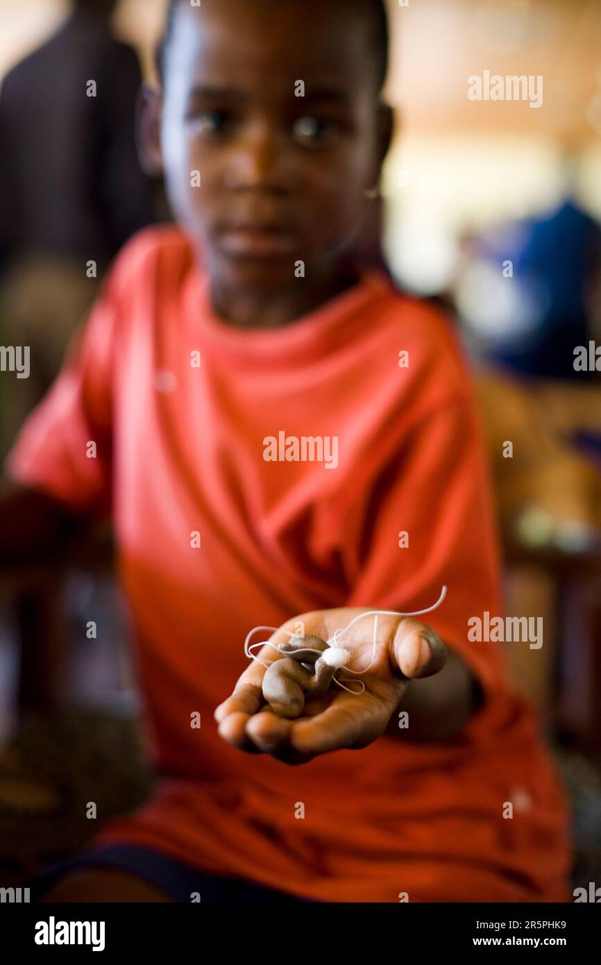 A young boy holds his ear impressions as he awaits new molds for hearing aids. Stock Photo