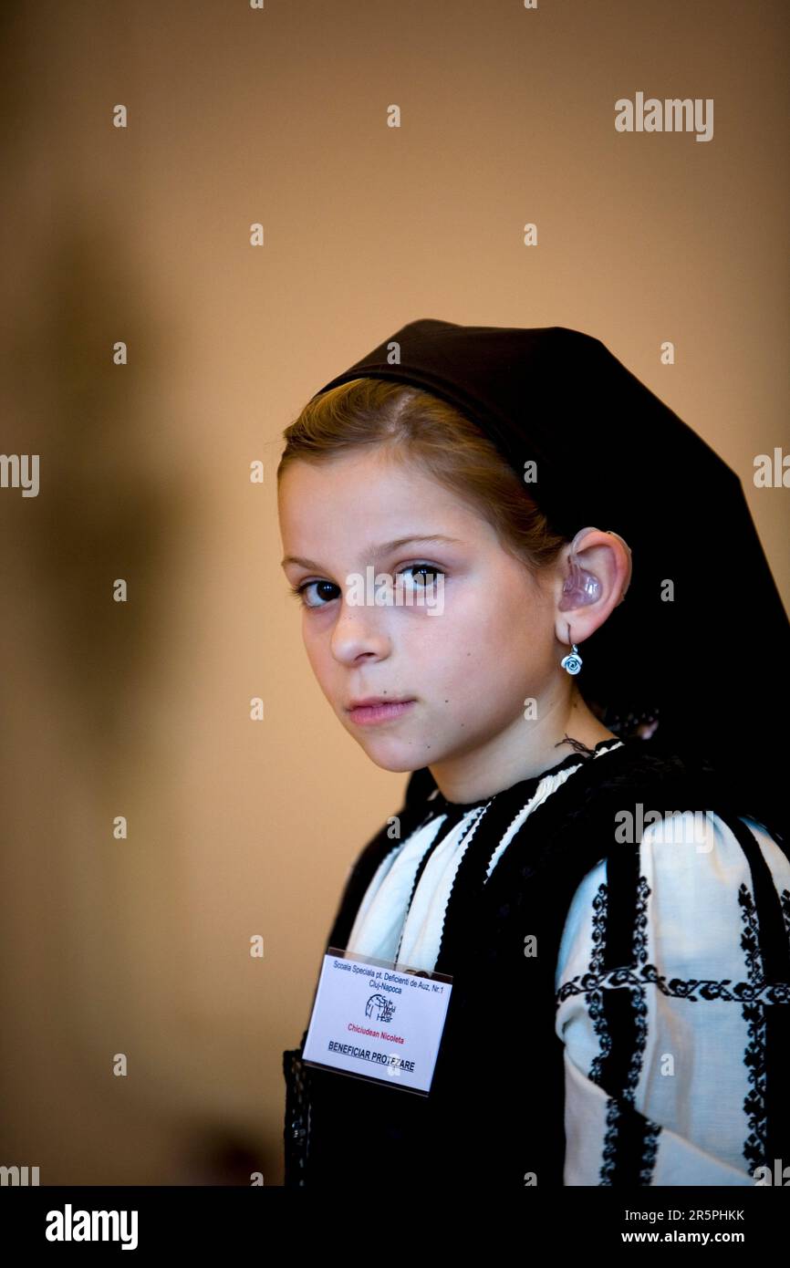 A young Romanian girl, who has had genetic hearing loss from birth was fit with hearing aids during the Starkey Hearing Foundation mission to Romania. Stock Photo