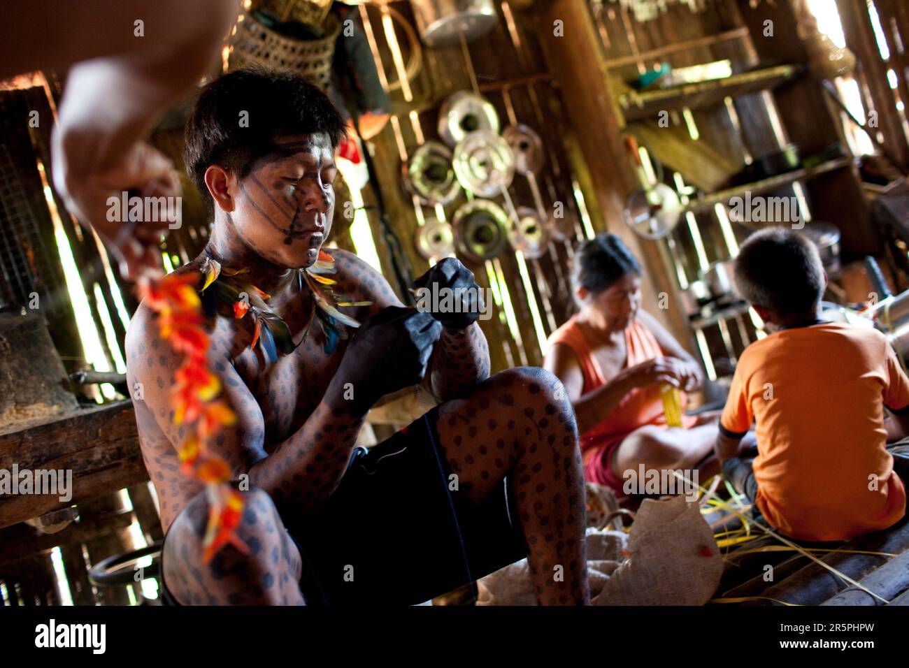 Members of the Oro Win tribe make preparations and body decorations for an upcoming traditional 'festa' or celebration, Sao Luis Indian Post, Brazil. Stock Photo