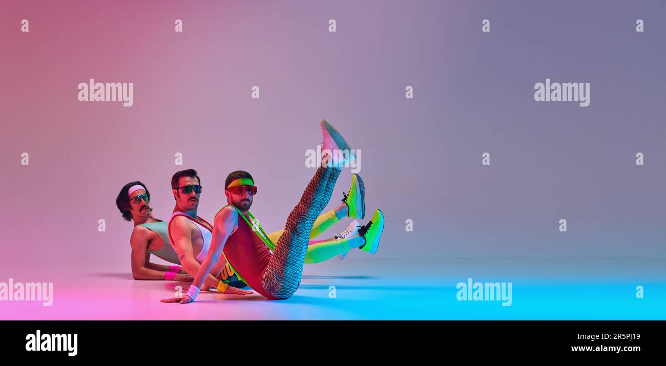 Men in colorful retro sportswear doing aerobics exercises against ...