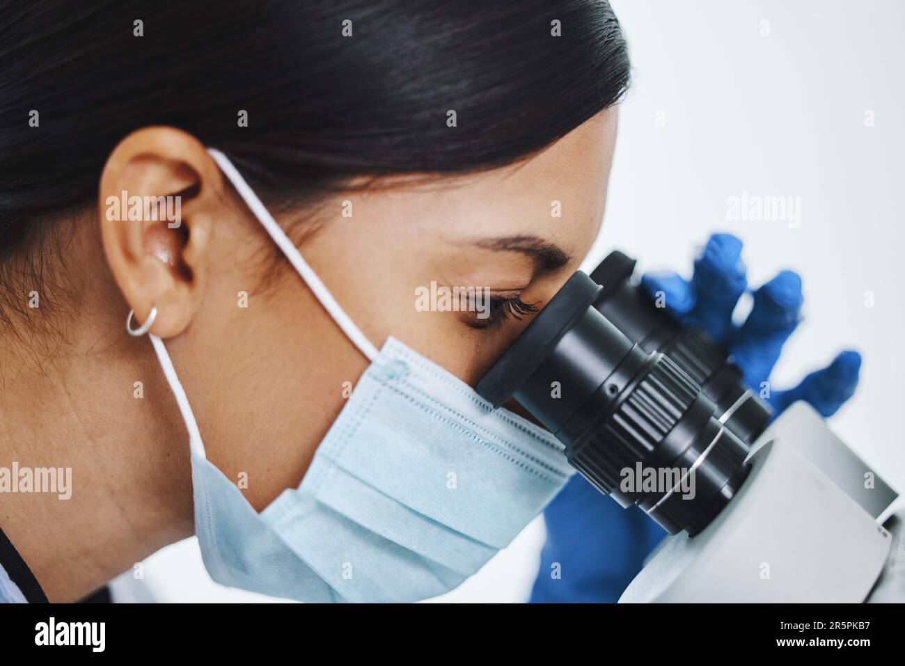 Science, laboratory and face of woman with microscope for medical ...