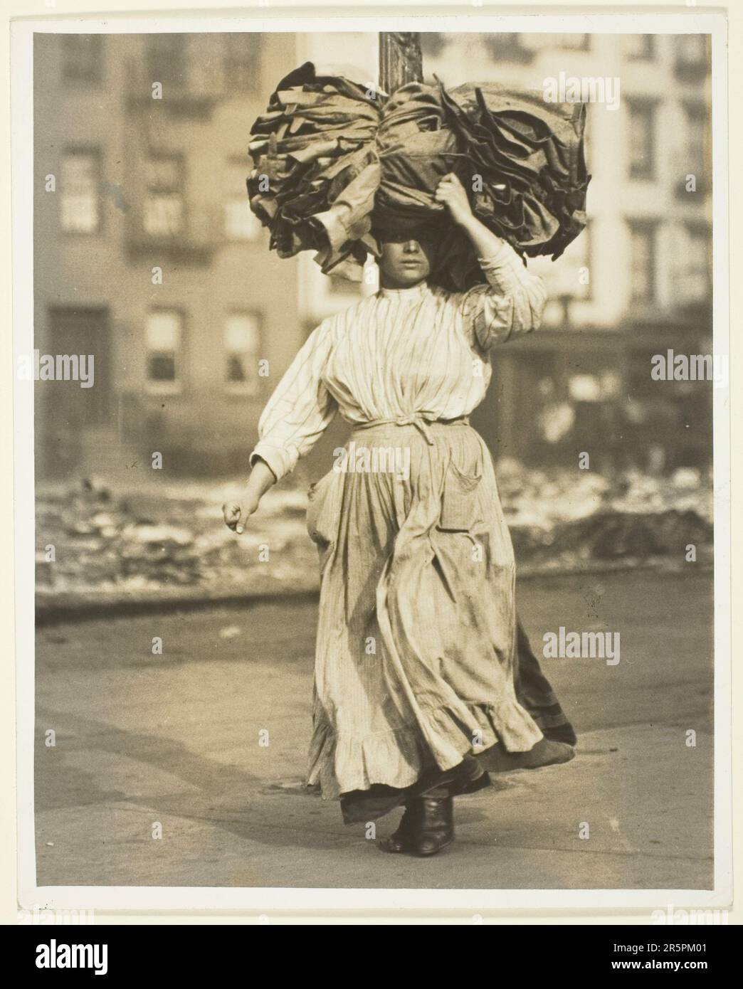 First Work in America, Italian Immigrant Carries Garments To The Tenement Home Date: 1910 Artist: Lewis Wickes Hine American, 1874–1940 Stock Photo