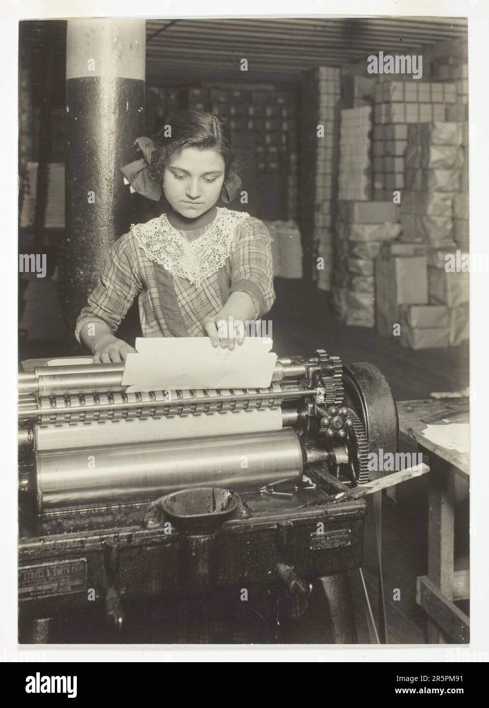 Young Worker in Paper Box Factory Date: 1912 Artist: Lewis Wickes Hine American, 1874–1940 Stock Photo