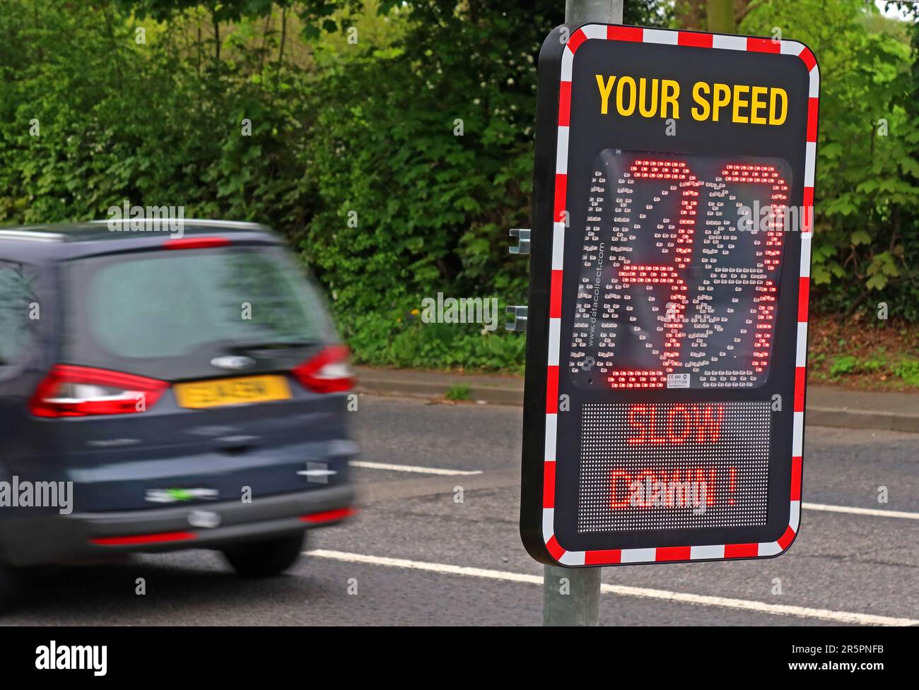 Electronic roadside speed indicator displaying “Your Speed 37” and “Slow Down” on Bellhouse Lane, Grappenhall, a 30 mph residential road in Cheshire Stock Photo