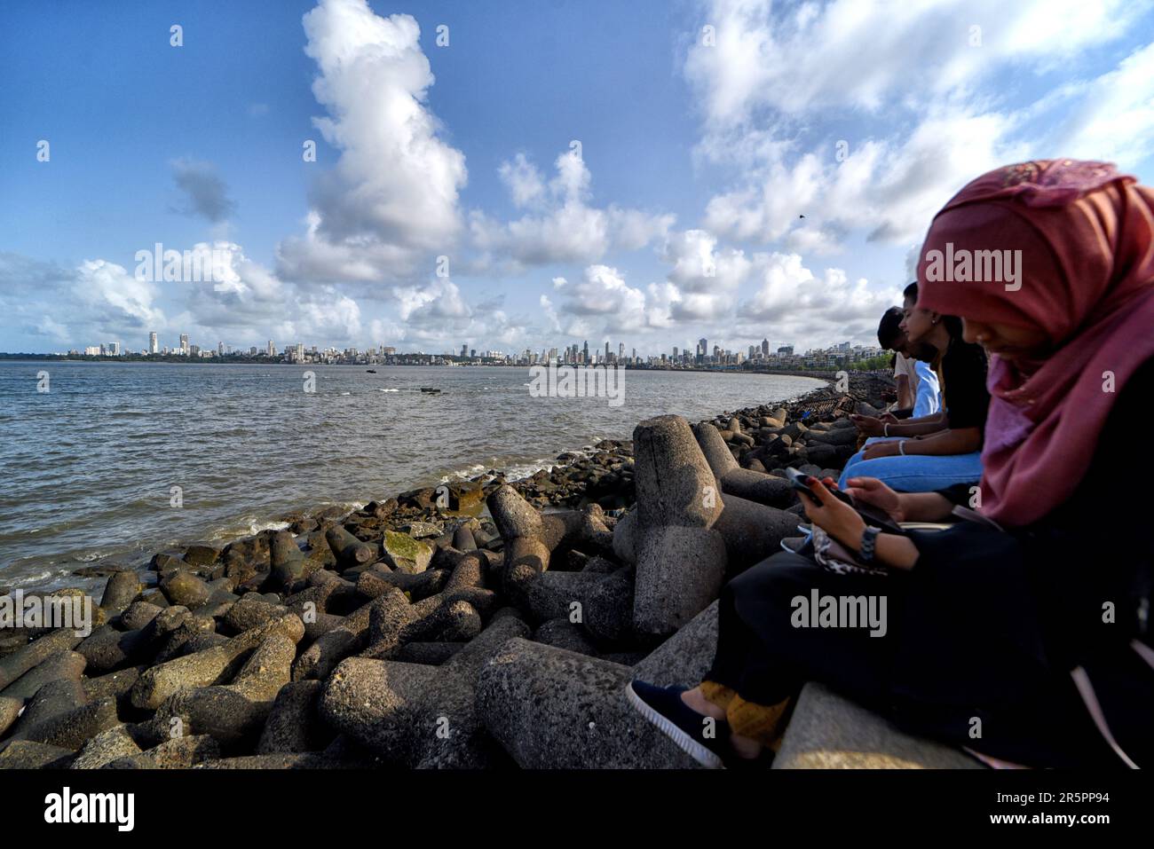 People seen enjoying the beauty of Arabian Sea as seen seating on the